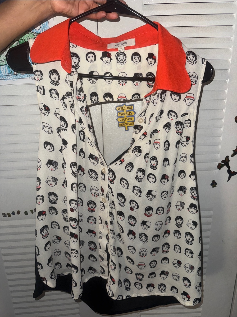 Umgee Cream Sleeveless Blouse with Black Face Print and Orange Collar